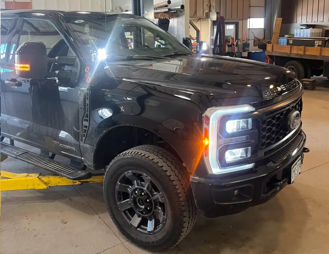 Fleet & Diesel Repair in Carbondale, CO by JW Diesel & Automotive. A black truck with lights on inside an auto repair shop.