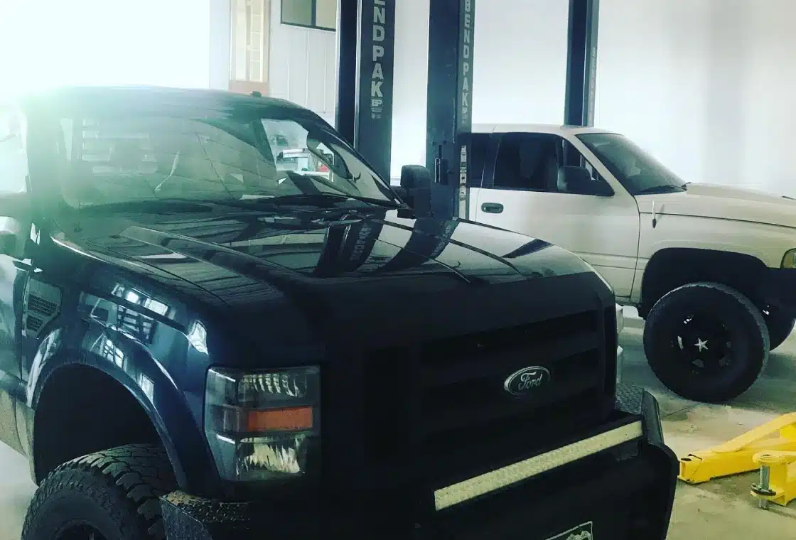 a black truck parked in a garage